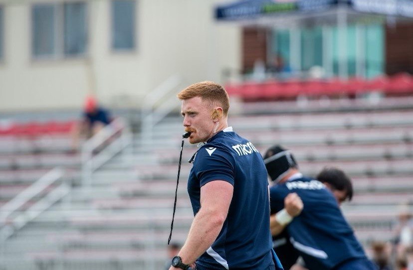 Mathew Skyner coaching from the rugby sideline with a whistle
