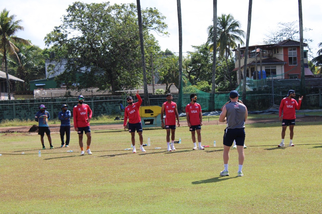Mathew Skyner working with a USA Cricket training group on the field